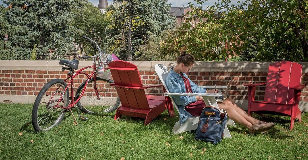 Student on lawn reading