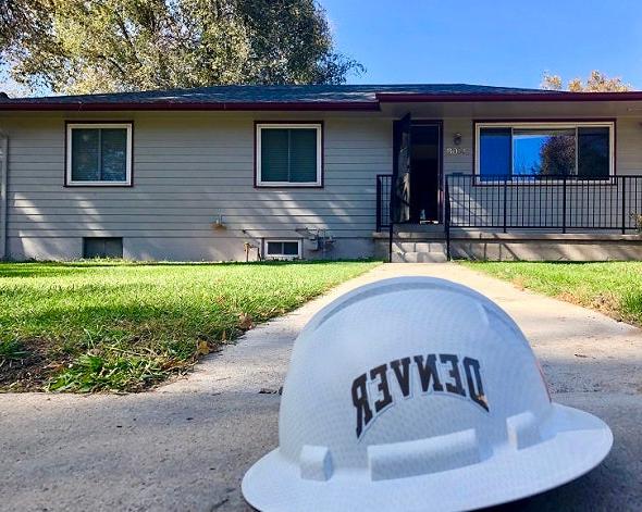 hard hat in front of Solar Decathlon house 